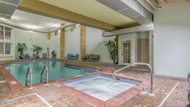 view of pool with an indoor hot tub