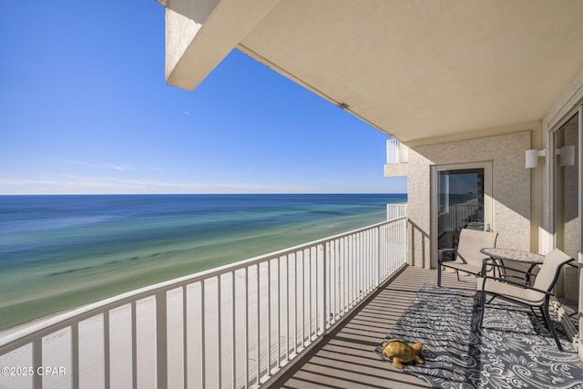 balcony with a beach view and a water view