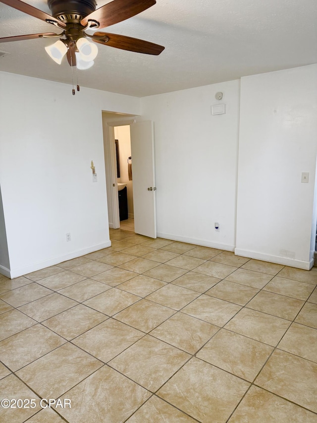 unfurnished room featuring ceiling fan and light tile patterned flooring