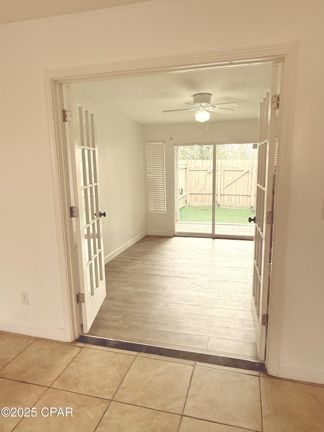 interior space with light tile patterned flooring and french doors