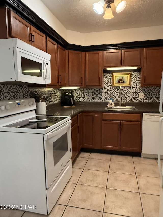 kitchen with white appliances, a textured ceiling, sink, backsplash, and light tile patterned floors