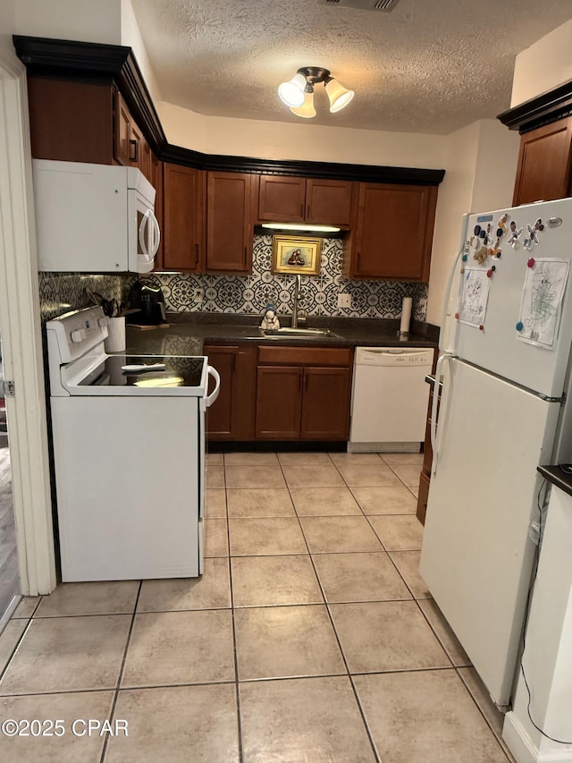 kitchen featuring sink, white appliances, tasteful backsplash, and light tile patterned flooring