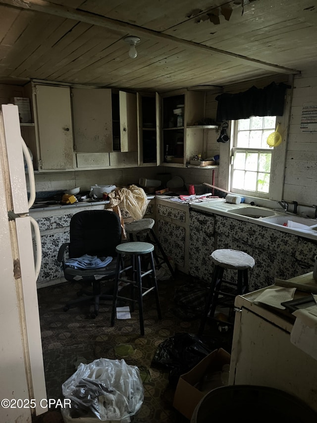 kitchen with sink, wooden ceiling, and white fridge
