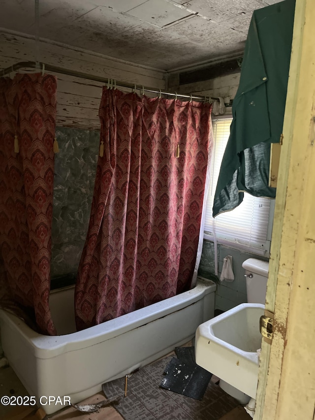 bathroom featuring sink and shower / bath combo with shower curtain