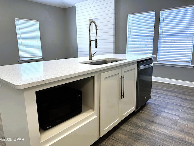 kitchen with dark wood-type flooring, sink, white cabinetry, light stone counters, and stainless steel dishwasher