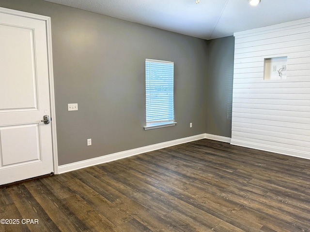 spare room with dark hardwood / wood-style floors