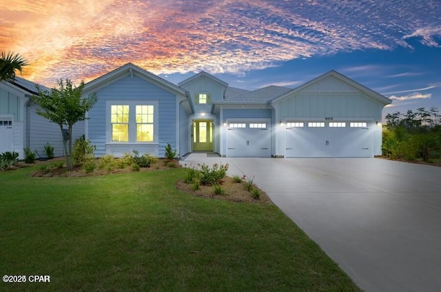 view of front of home featuring a garage and a lawn