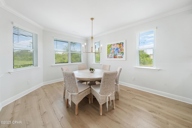 dining room with a notable chandelier, ornamental molding, and light wood-type flooring