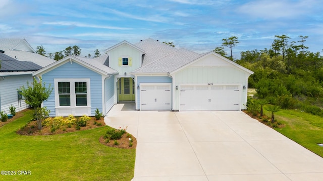 view of front of house featuring a garage and a front yard