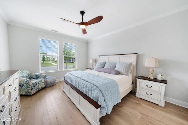 bedroom with ceiling fan, ornamental molding, and light hardwood / wood-style flooring