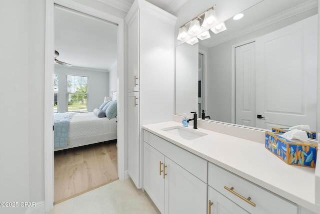 bathroom with vanity, wood-type flooring, and ornamental molding