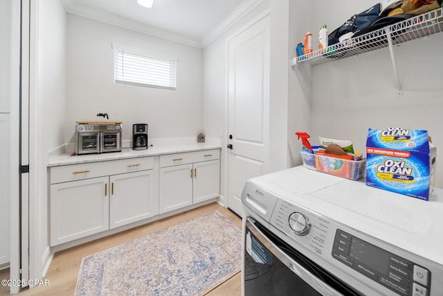 laundry room with ornamental molding, washer / clothes dryer, and light hardwood / wood-style floors