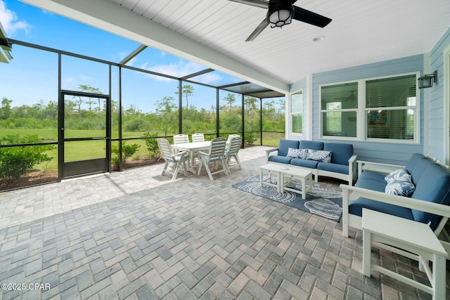 sunroom / solarium featuring ceiling fan