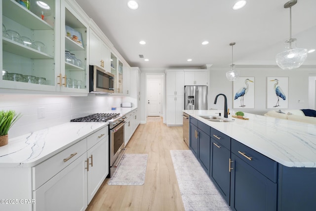 kitchen featuring white cabinetry, appliances with stainless steel finishes, sink, and pendant lighting