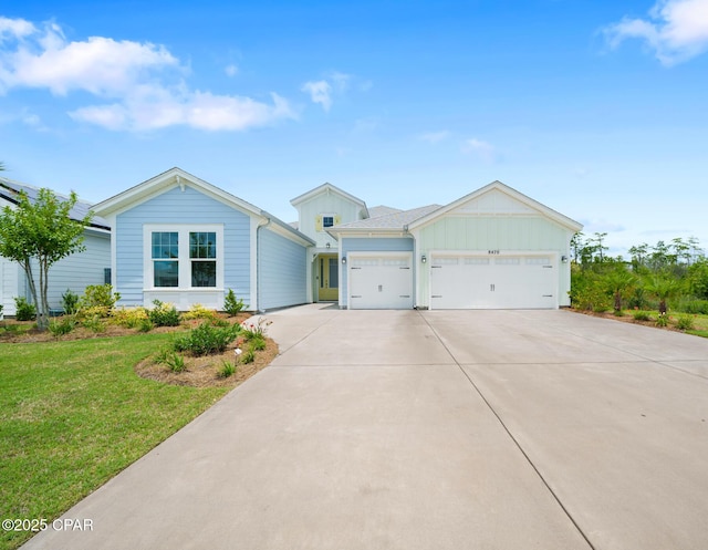 ranch-style house featuring a garage and a front lawn