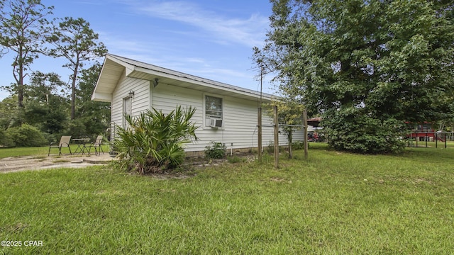 view of side of home featuring a yard