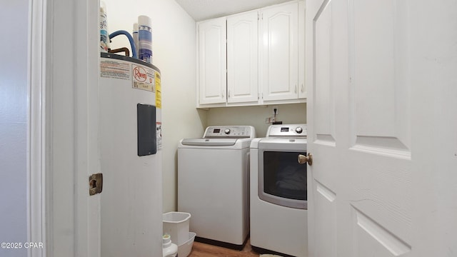 11413 Church Rd, Ebro, FL 32437 - laundry room with washing machine and clothes dryer, cabinet space, water heater, and light wood-style flooring