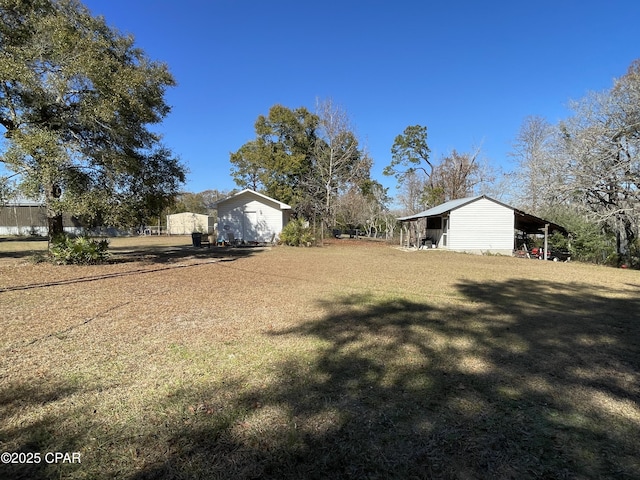 11413 Church Rd, Ebro, FL 32437 - view of green lawn with an outbuilding