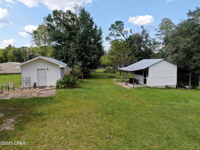 11413 Church Rd, Ebro, FL 32437 - view of grassy yard with an outdoor structure and view of wooded area