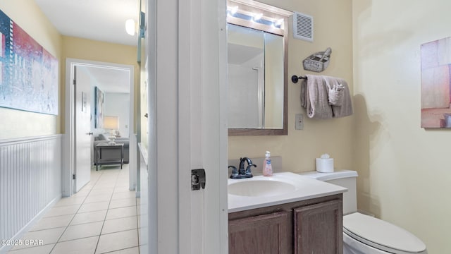 bathroom with vanity, toilet, and tile patterned flooring