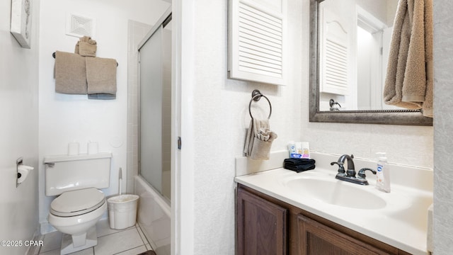 full bathroom with bath / shower combo with glass door, vanity, tile patterned floors, and toilet