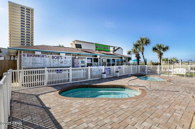 view of swimming pool with a hot tub and a patio