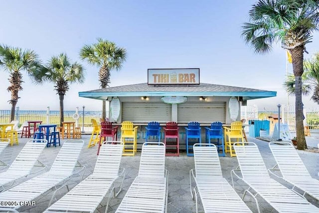 view of patio with a water view and exterior bar