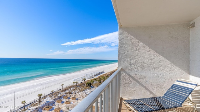 balcony with a water view and a beach view