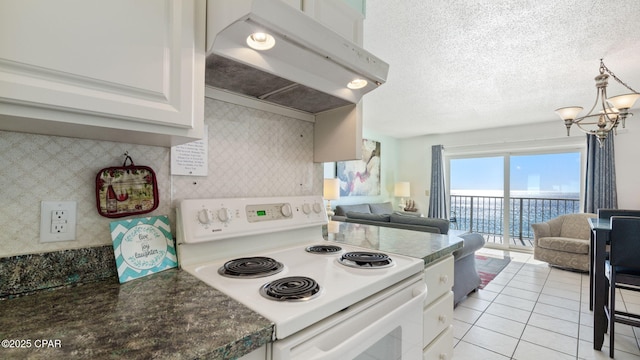 kitchen with white cabinetry, light tile patterned flooring, a chandelier, and white range with electric cooktop