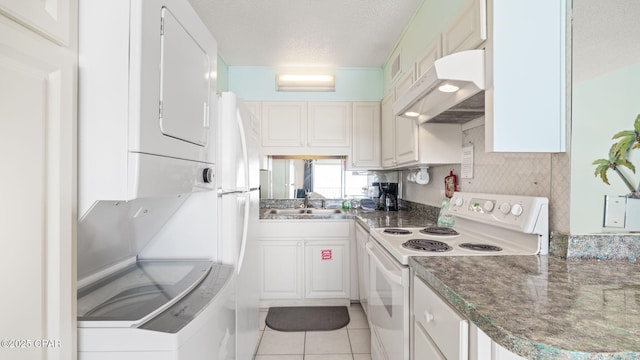 kitchen with sink, light tile patterned floors, white cabinets, and white range with electric stovetop