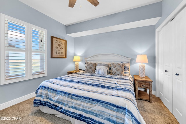 carpeted bedroom featuring ceiling fan, multiple windows, and a closet