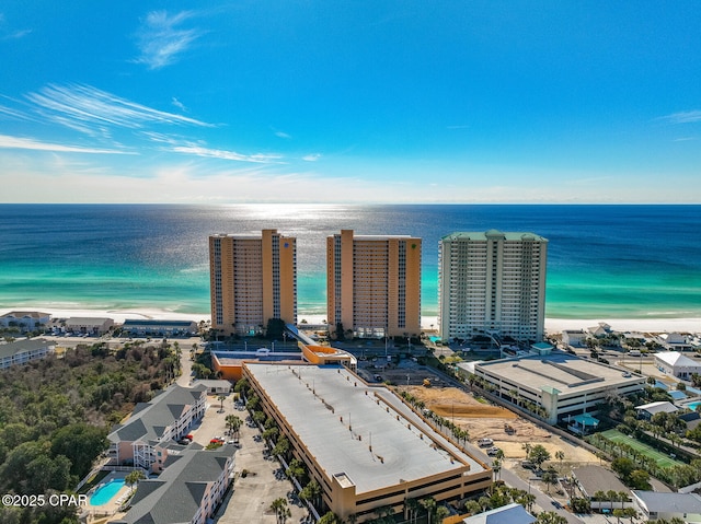 birds eye view of property with a water view and a beach view