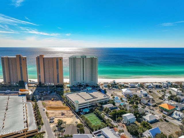 birds eye view of property with a water view and a beach view