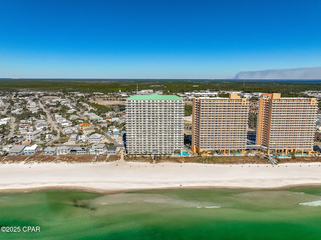 bird's eye view with a water view and a beach view