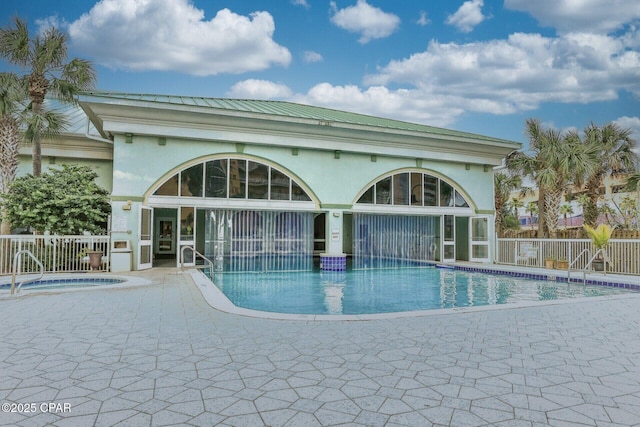 view of swimming pool featuring a patio and a hot tub