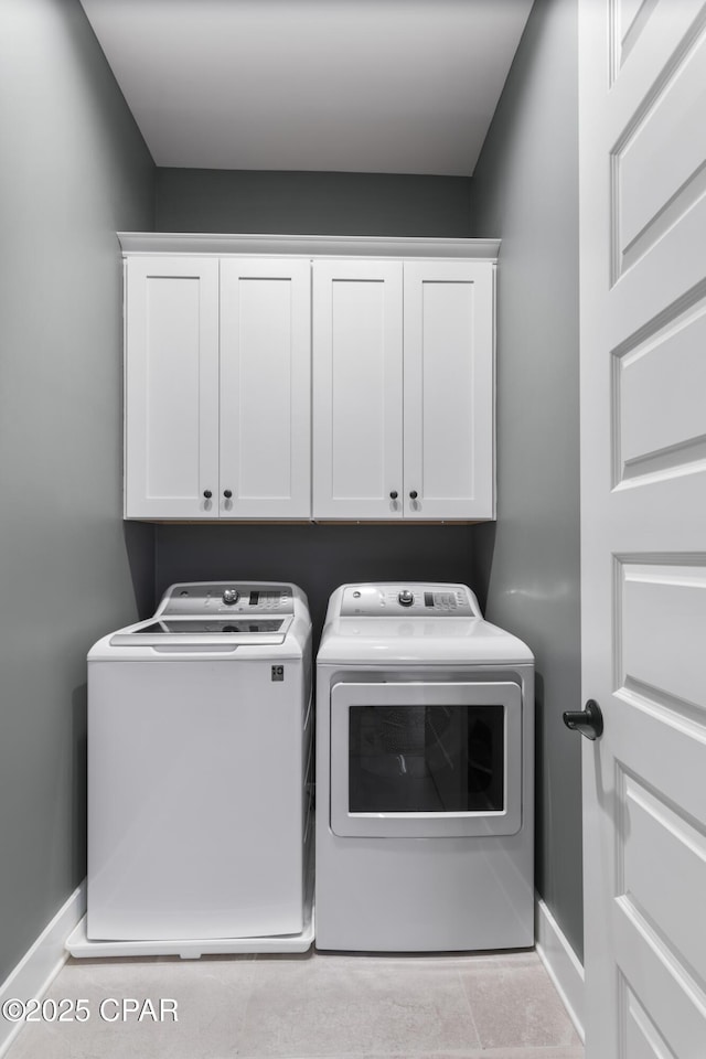 washroom with cabinets and independent washer and dryer