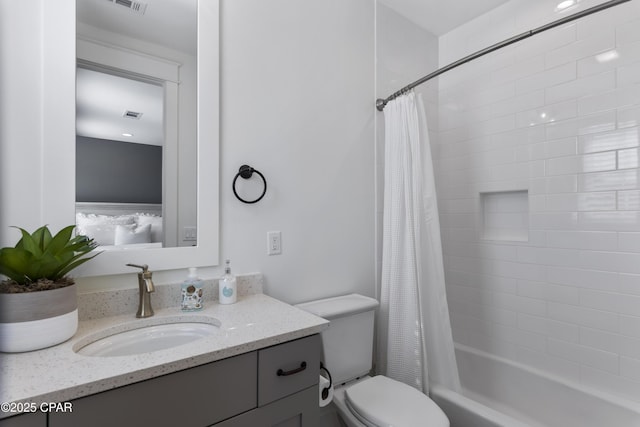 full bathroom with vanity, shower / tub combo with curtain, and toilet