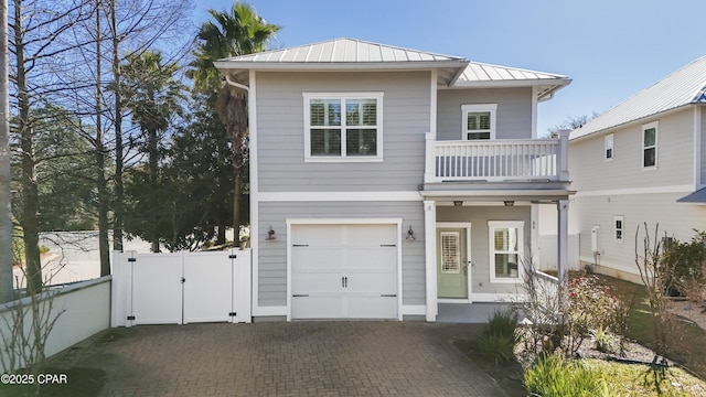 view of front facade featuring a balcony and a garage