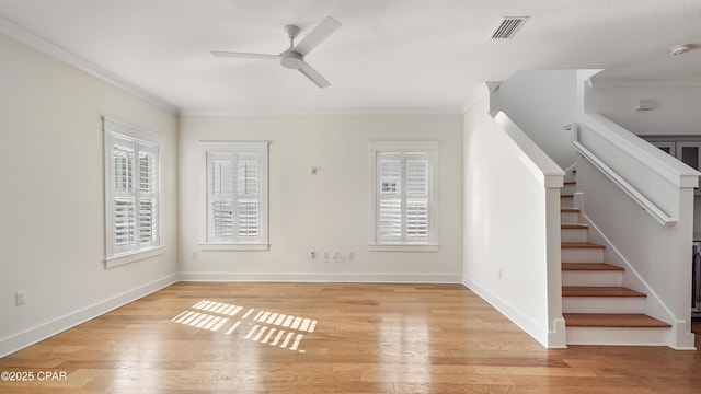 unfurnished living room featuring crown molding, light hardwood / wood-style floors, and ceiling fan