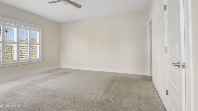 carpeted spare room with ceiling fan