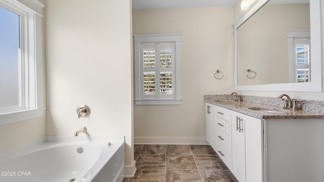 bathroom with vanity and a bath