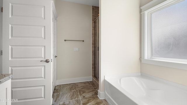 bathroom featuring shower with separate bathtub and vanity