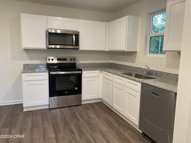 kitchen featuring white cabinetry, stainless steel appliances, light stone countertops, and sink