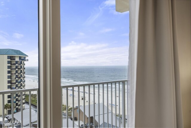 balcony featuring a view of the beach and a water view