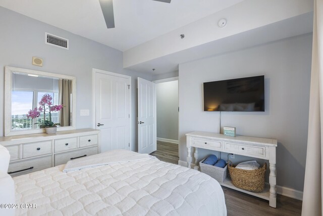 bedroom with dark hardwood / wood-style flooring and ceiling fan