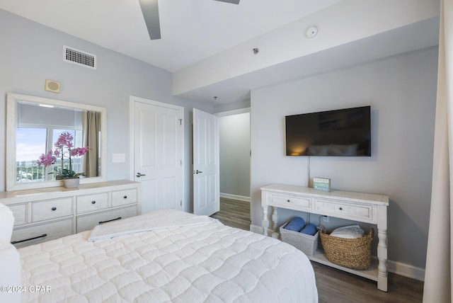 bedroom with visible vents, ceiling fan, dark wood-type flooring, and baseboards