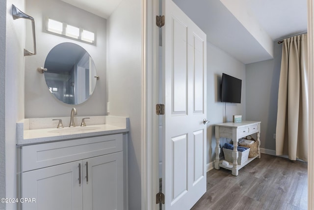 bathroom with hardwood / wood-style flooring and vanity