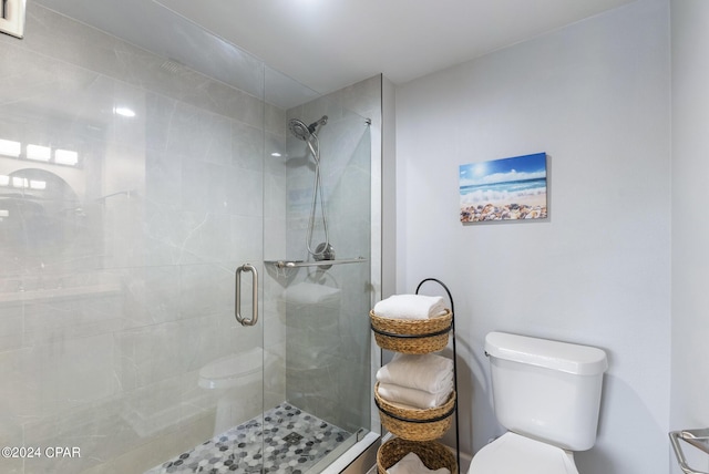 bathroom featuring an enclosed shower and toilet