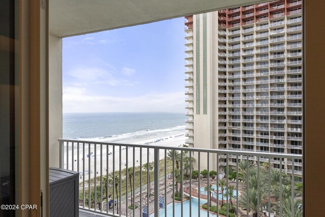 balcony featuring a water view and a view of the beach