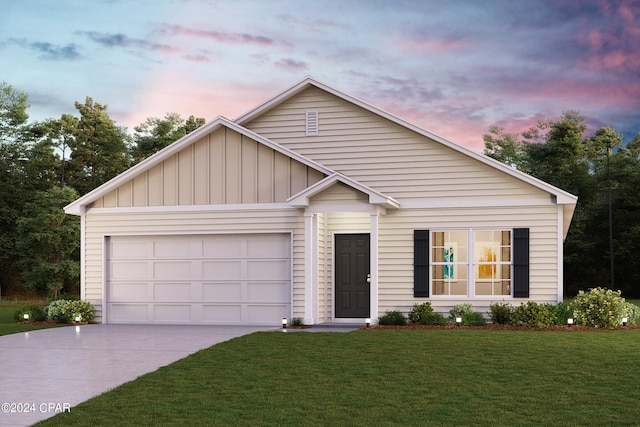 view of front of property featuring a garage and a lawn